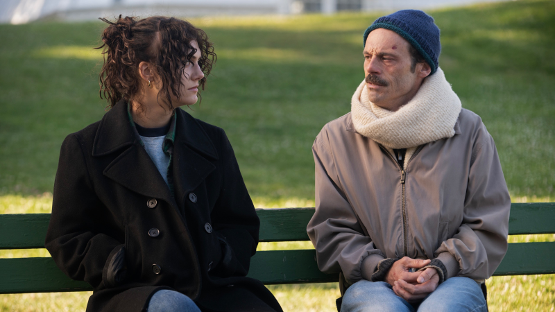 emilia jones and scoot mcnairy on a bench in fairyland