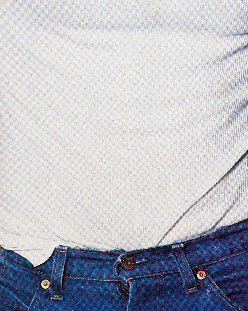 a close up of a white tee tucked into jeans