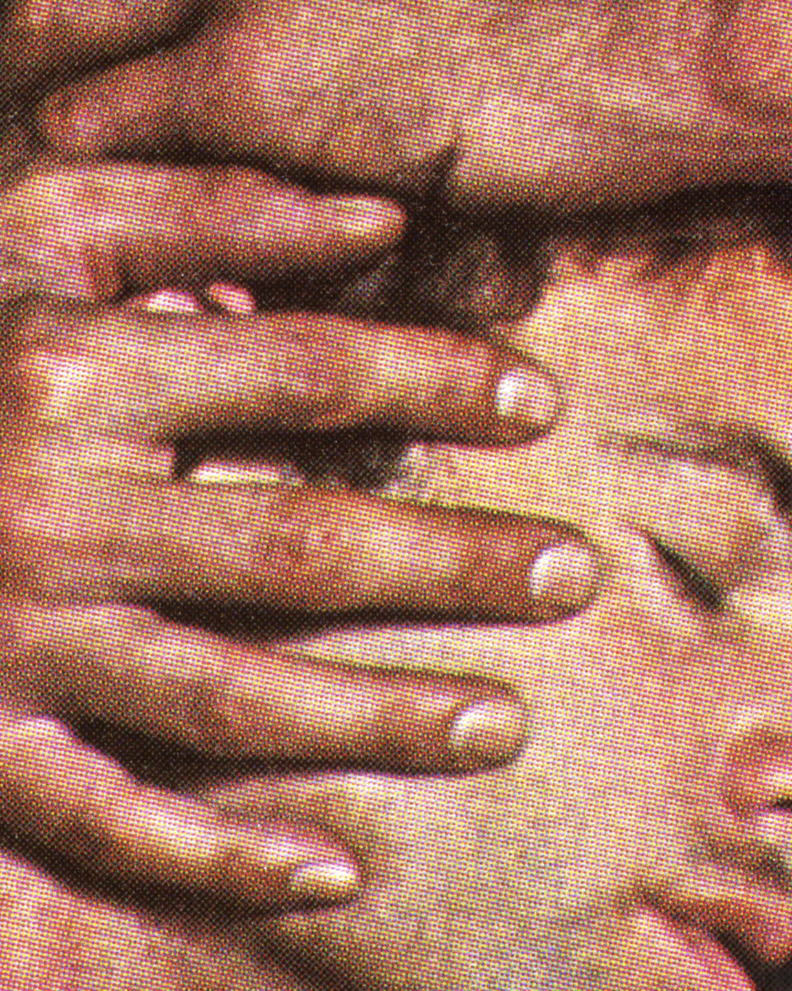 a grainy close up of a hand holding a man's face from behind, eyes closed in pleasure