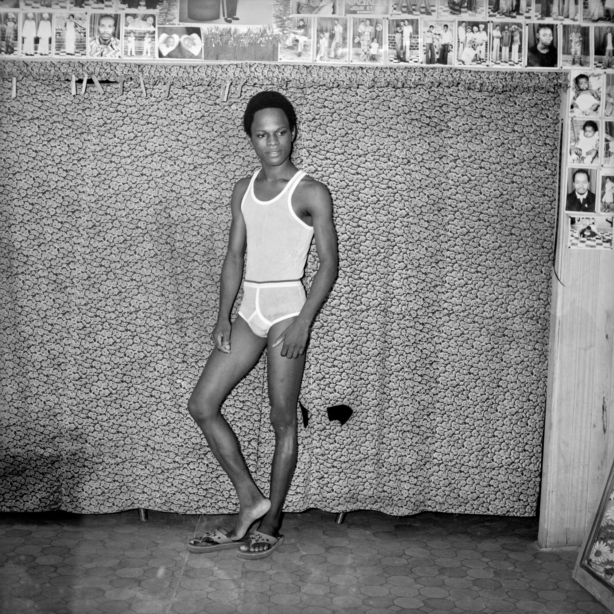 Samuel Fosso wearing white underwear in his studio.