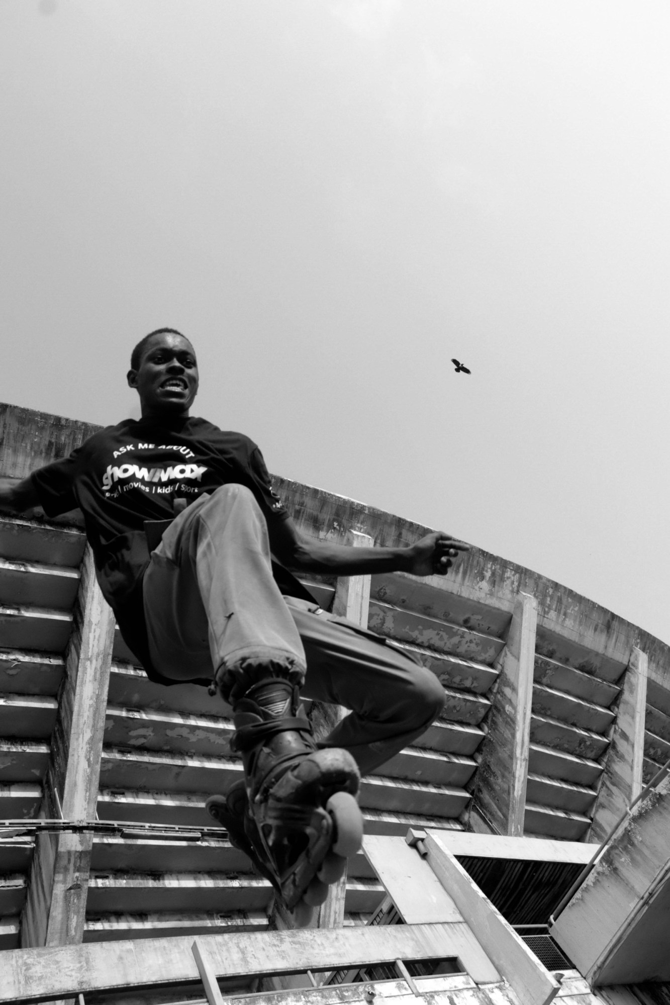 a shot from below of a roller blader dropping into a bowl