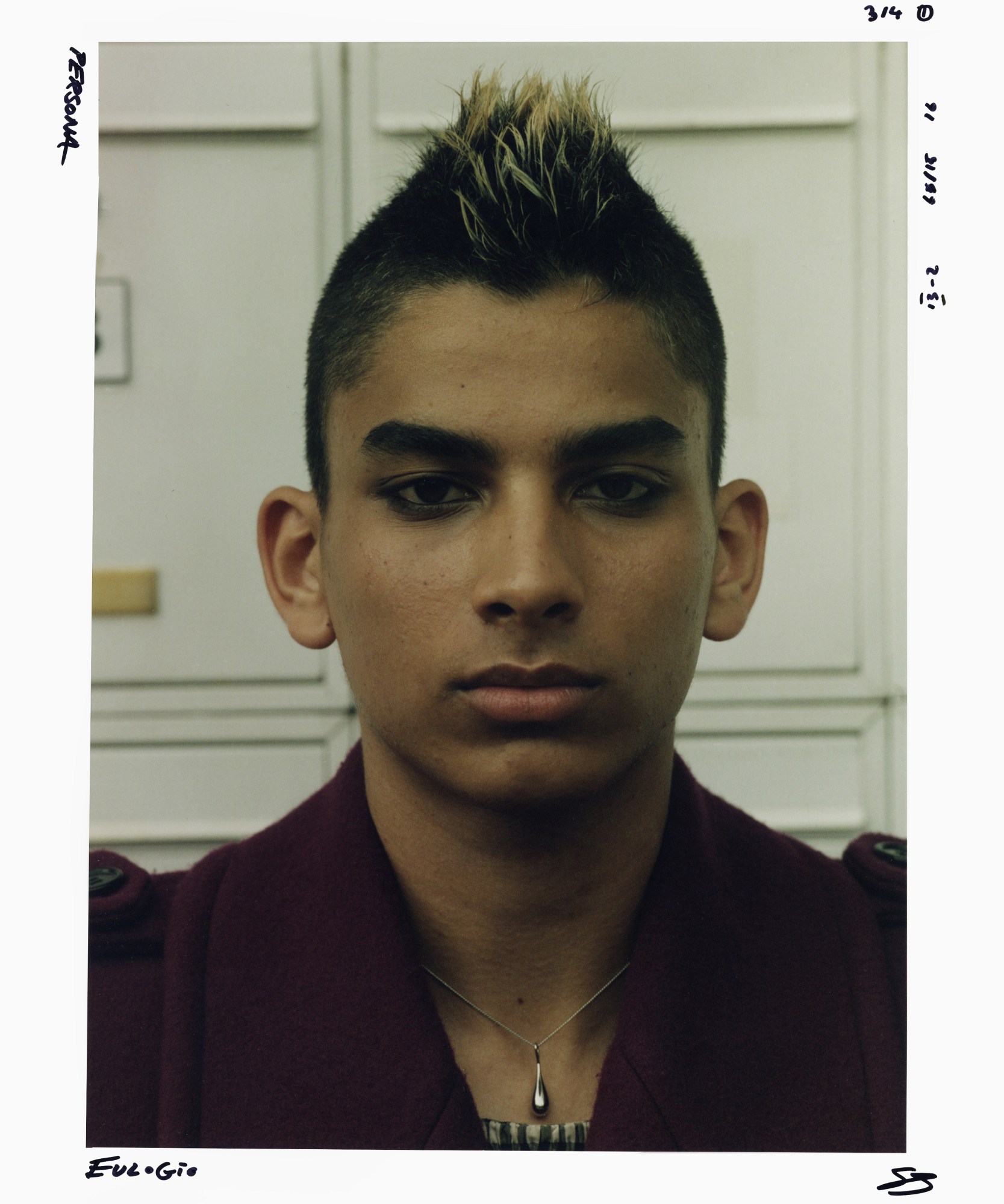 portrait of teenager with a mohawk and silver necklace