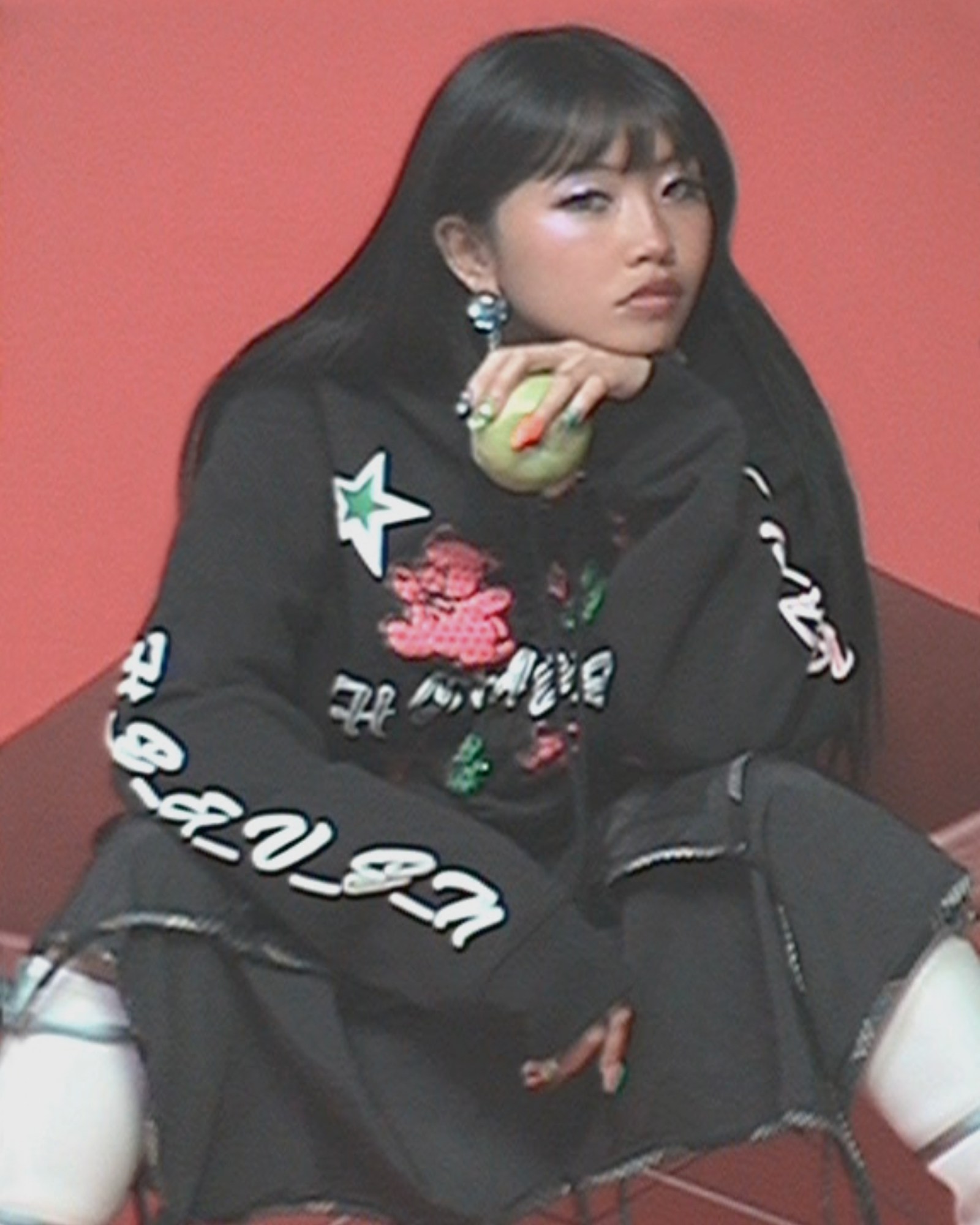 beabadoobee eating an apple while wearing MJ Heaven x Kiko