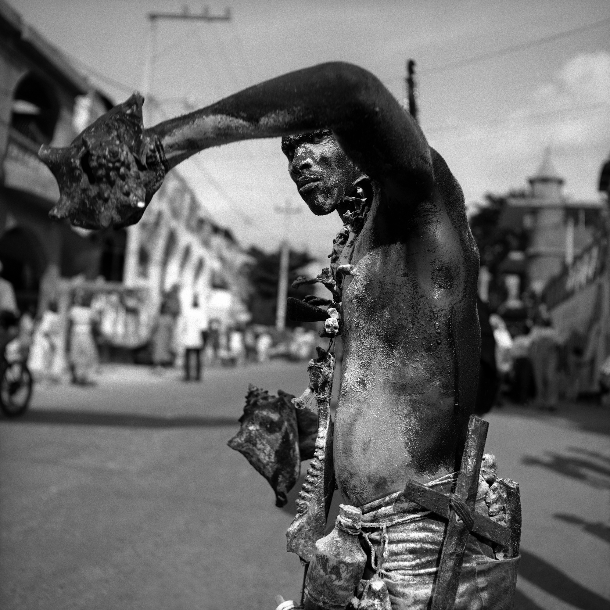 A man holding seashells covered in costume paint.