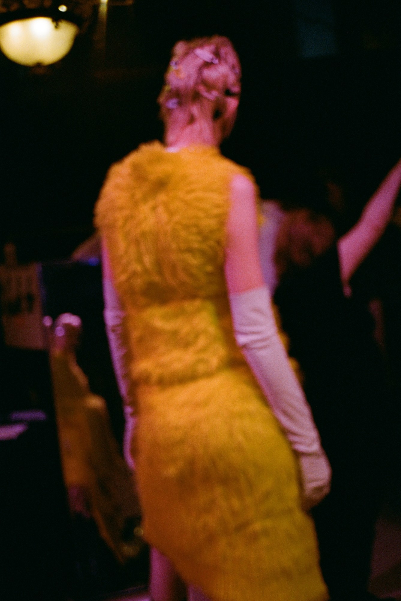 blurry photo of a model in a yellow furry dress at marc jacobs AW23