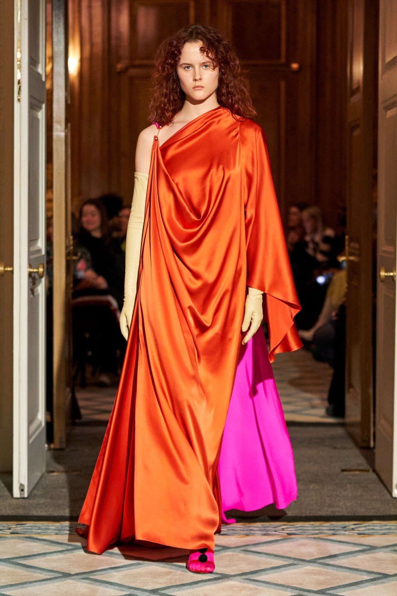 Model walking in an orange and pink silk gown at Roksanda AW23