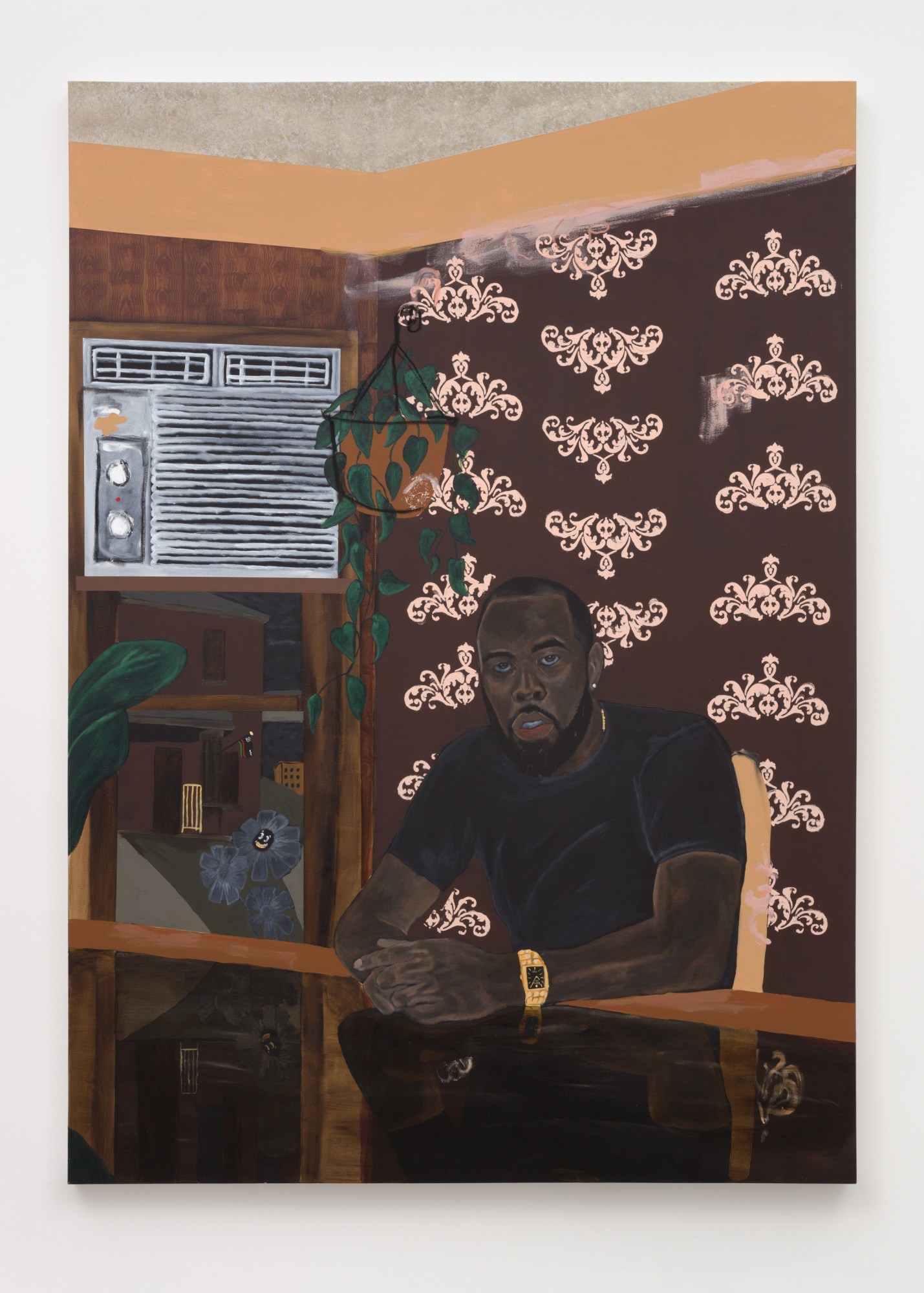 A self portrait of Jammie Holmes seated in front of a air conditioner and brown and pink wallpaper.