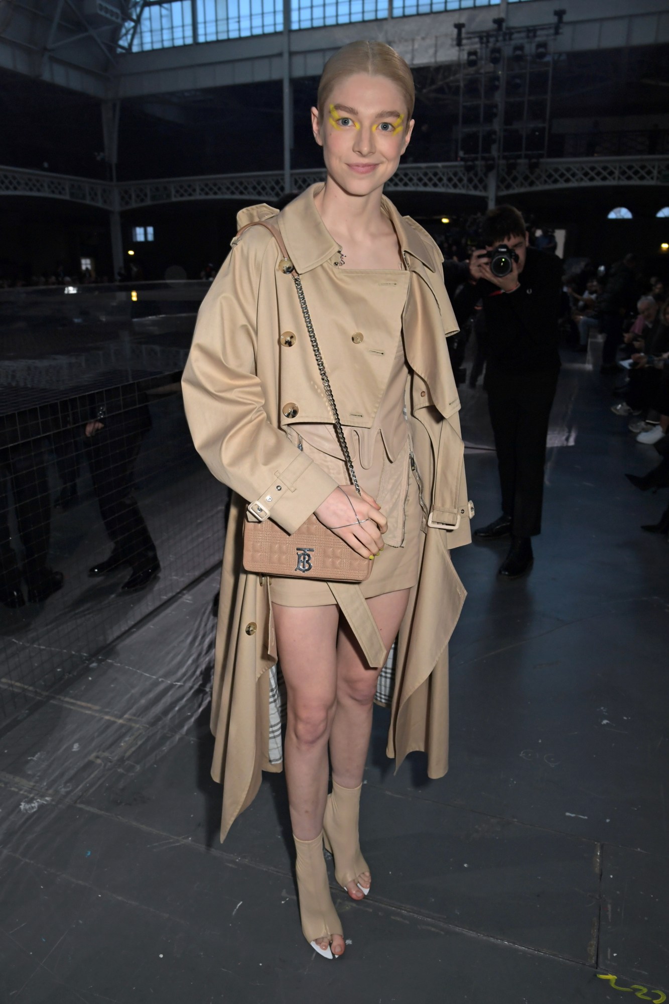 Hunter Schafer attends the Burberry Autumn/Winter 2020 show during London Fashion Week wearing a Burberry trench coat