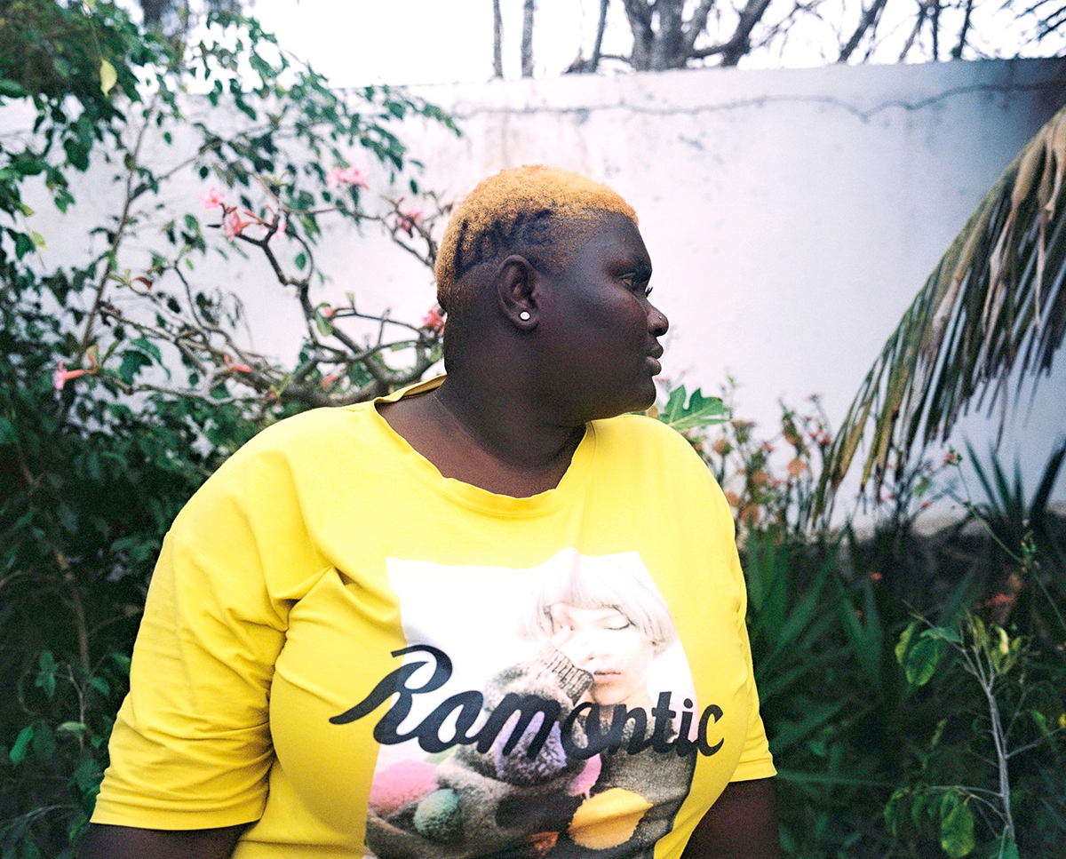 a woman with the word loved shaved into her head wearing a shirt that says romantic