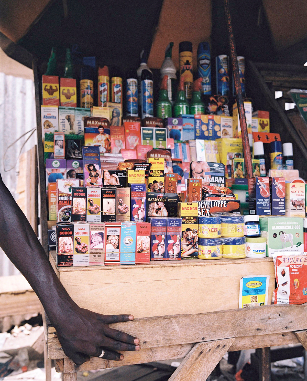 sex products for sale on a wooden stand in senegal