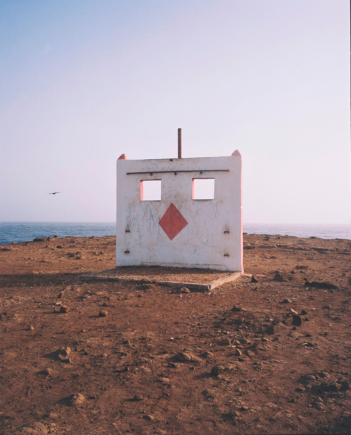 an abandoned concrete structure at the edge of the beach