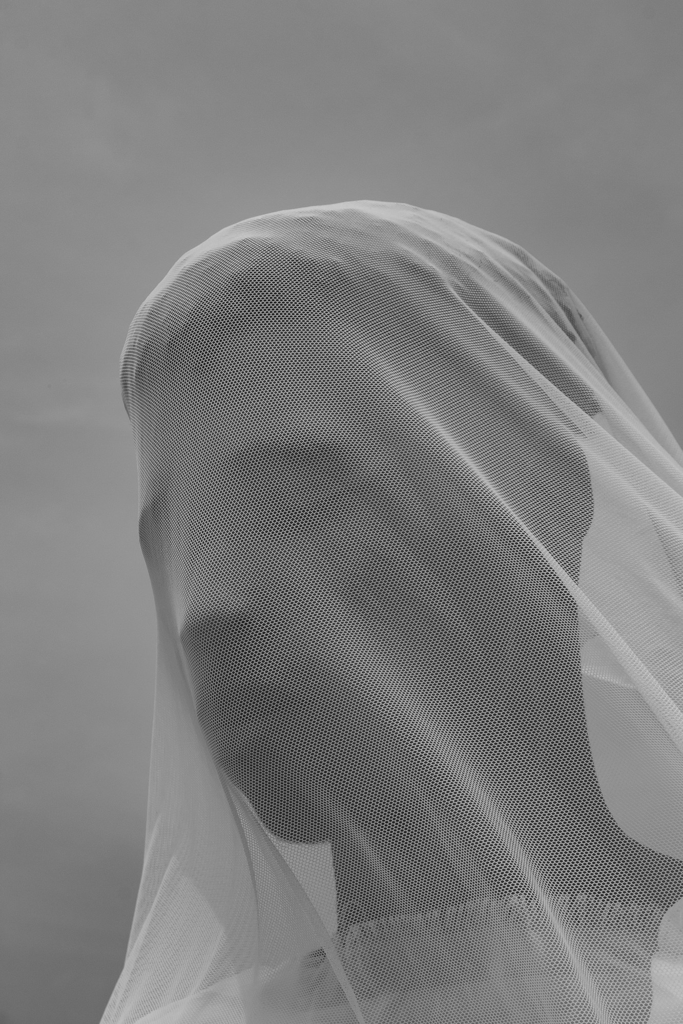 A man draped in white fabric.