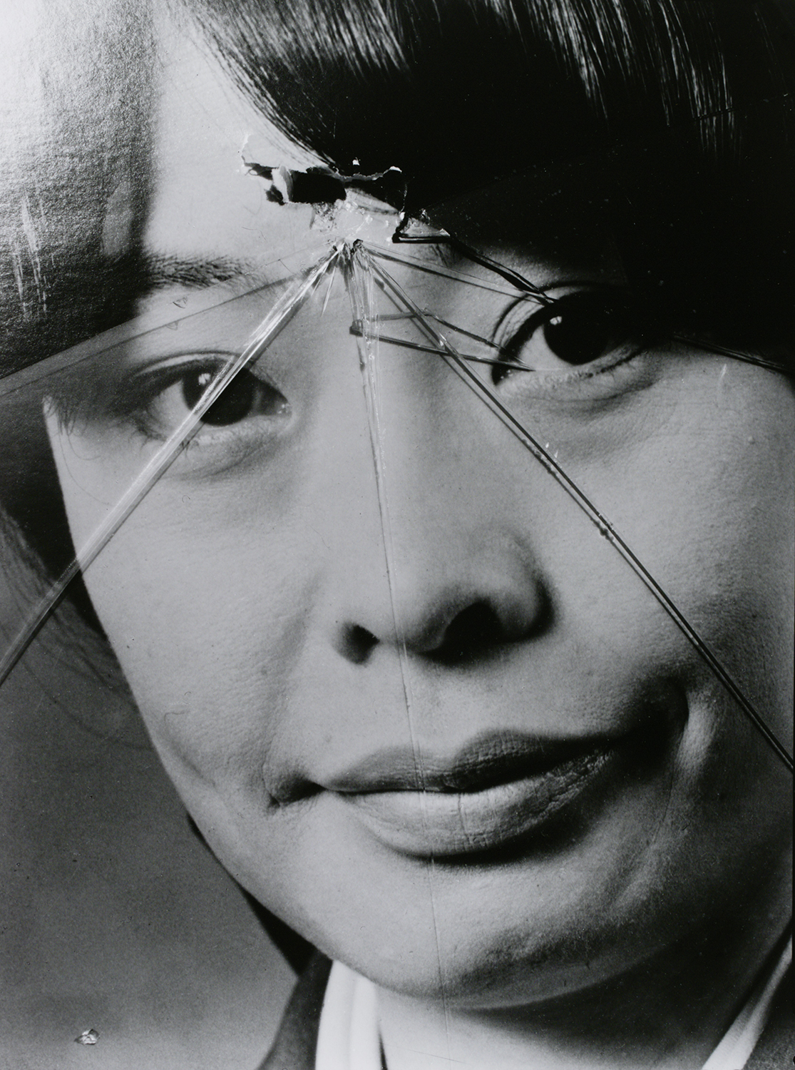 a close up portrait behind broken glass by masahisa fukase