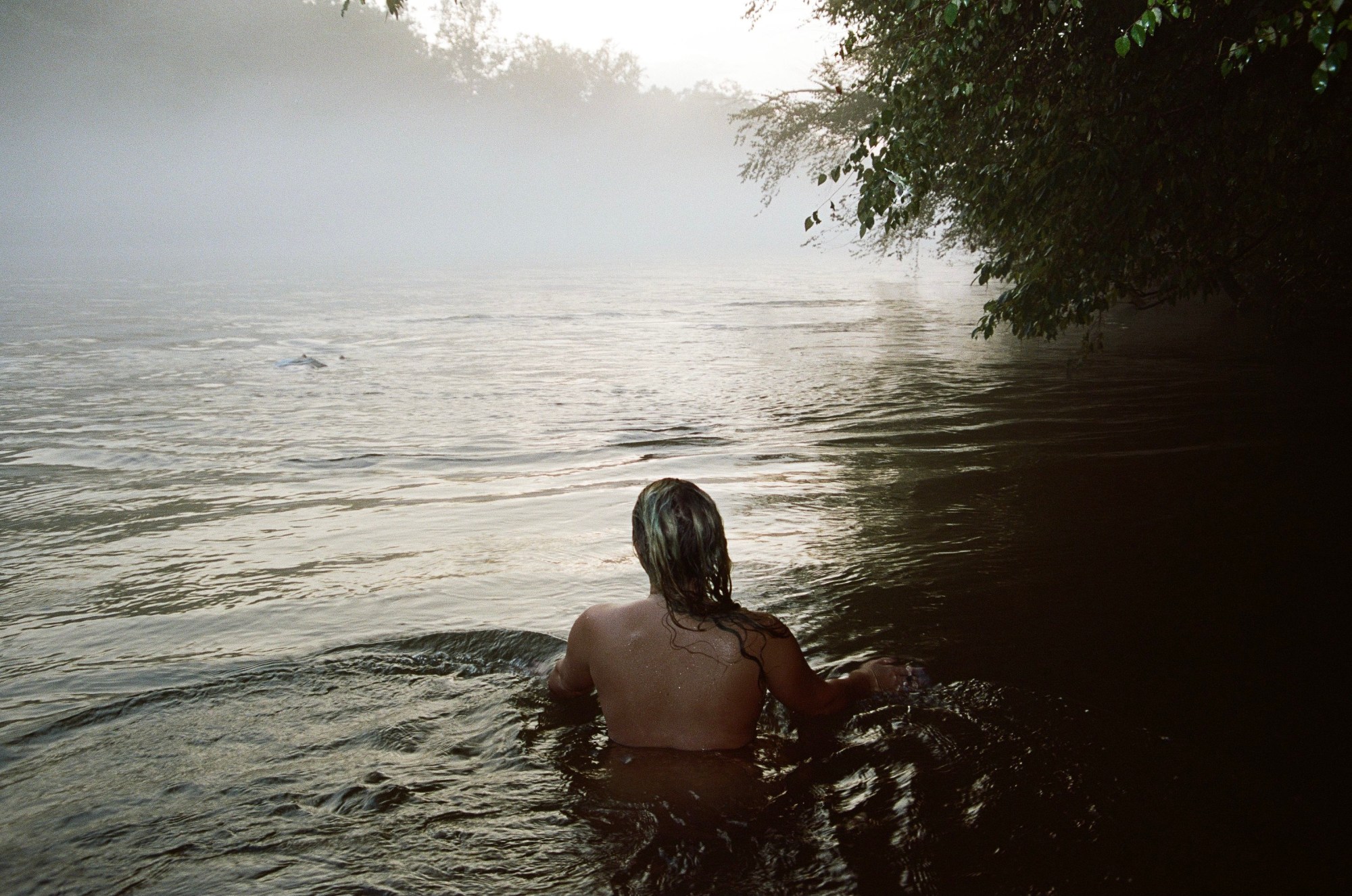 A woman swimming in an empty lake