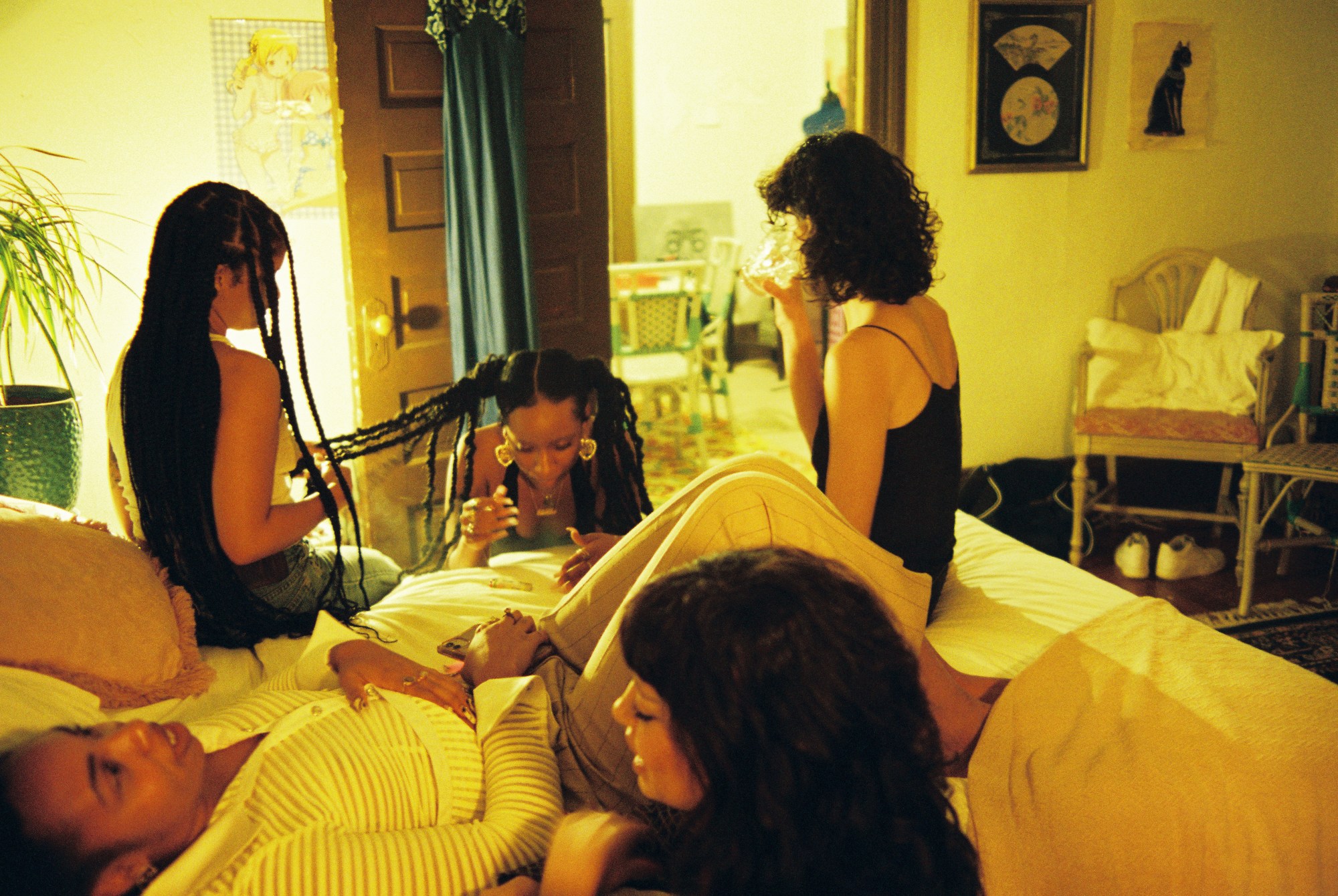 young women hanging out in a bedroom