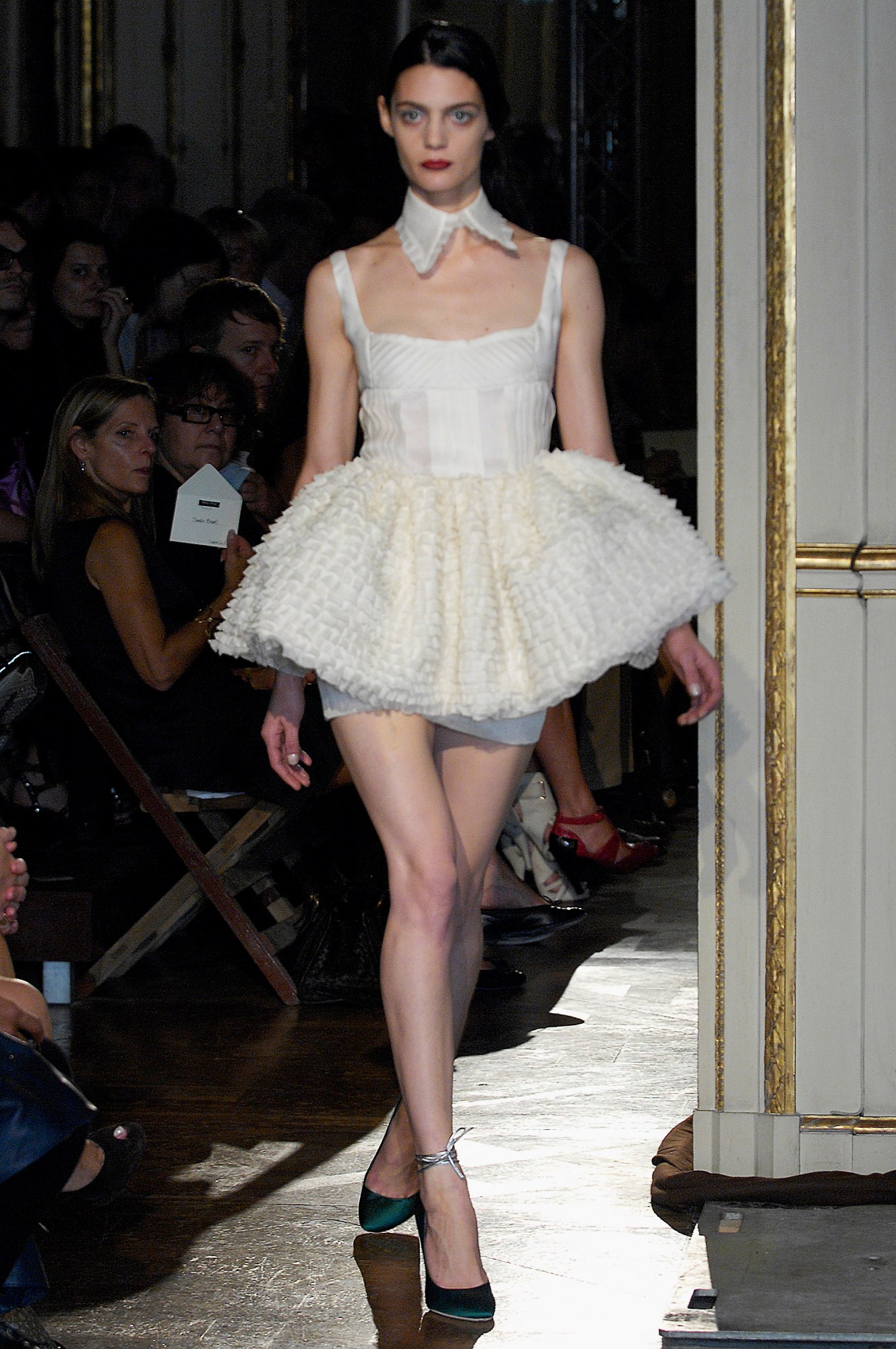 a model wearing a white ballerina tutu dress and collar on the miu miu runway 2008