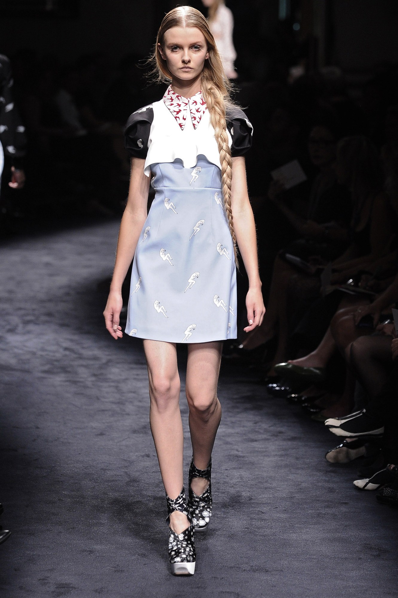 a model walking the miu miu 2010 runway in a twee printed dress