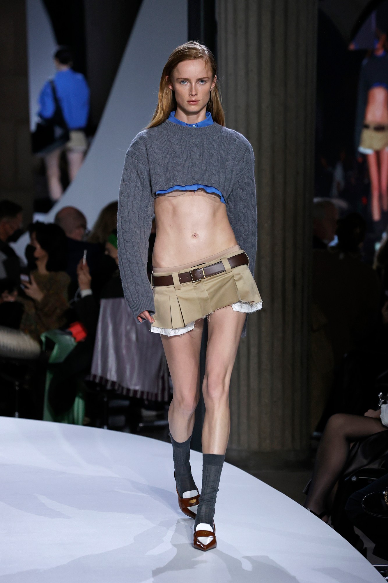 a model wearing the miu miu mini skirt on the runway for ss22 in paris