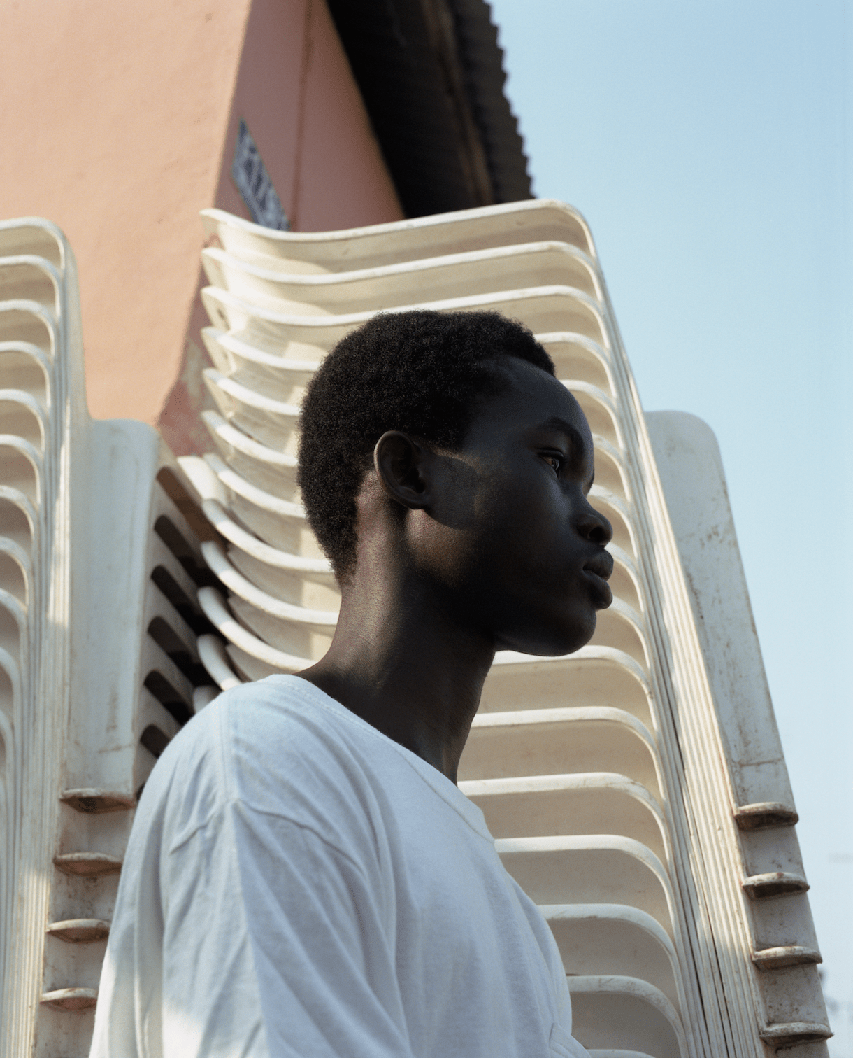 A young man standing in front of a white plastic structure