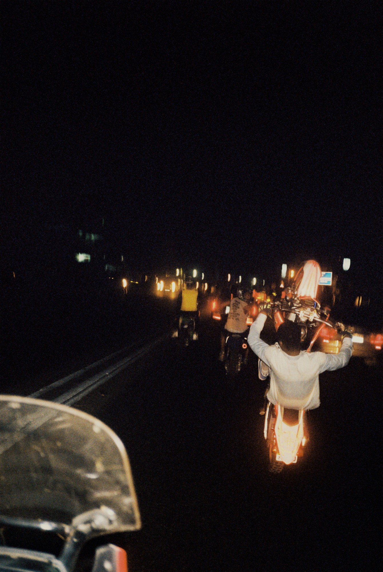 Racing bikes with reflective lights racing through the street at night