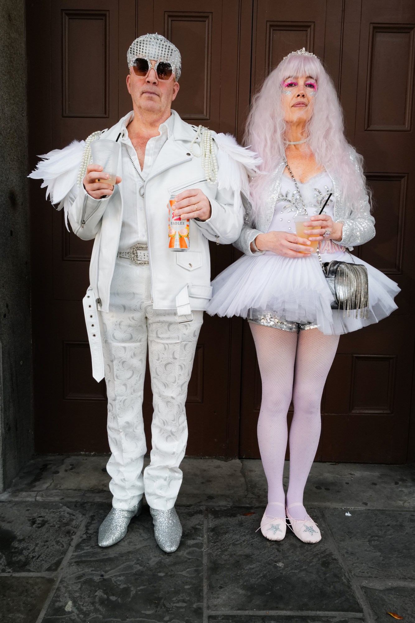 Photograph by Tom TBow Bowden of a couple, one in all white and vegas wear, the other dressed as a ballerina.