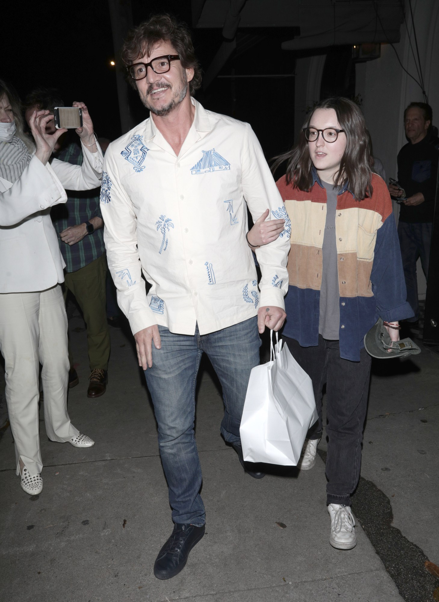 Pedro Pascal and Bella Ramsey are papped walking down the street with a takeout bag in LA in 2023