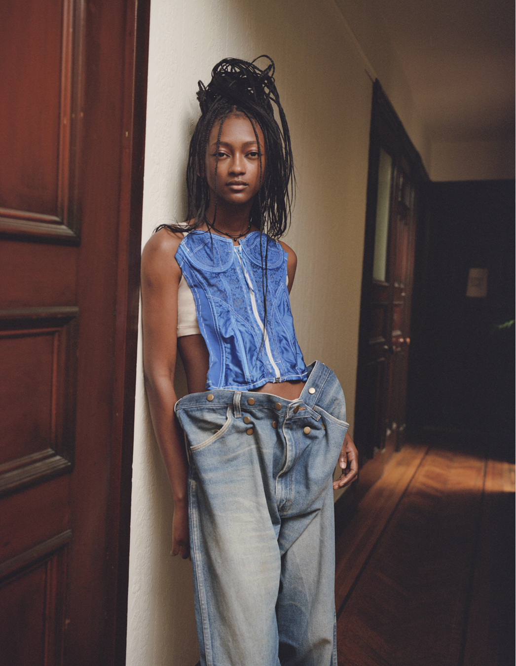 Model leaning against a wall wears dress by Ponte in a photograph by Deirdre Lewis in i-D’s The Timeless Issue, no. 371, Spring 2023