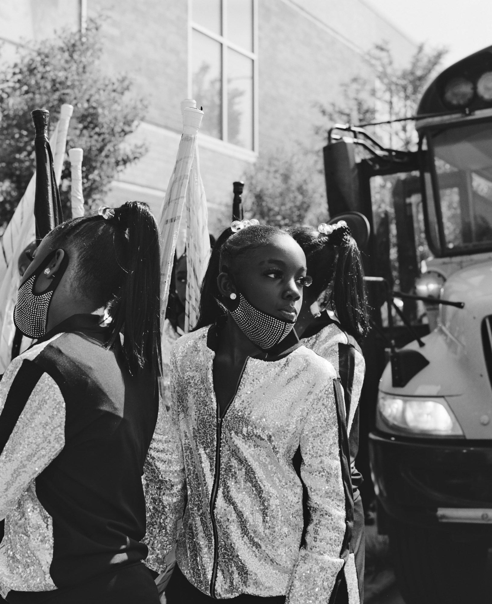 Black-and-white photo of young girls in Chicago's South Shore Drill Team wearing sparkly zip-up jackets and bejewelled face masks