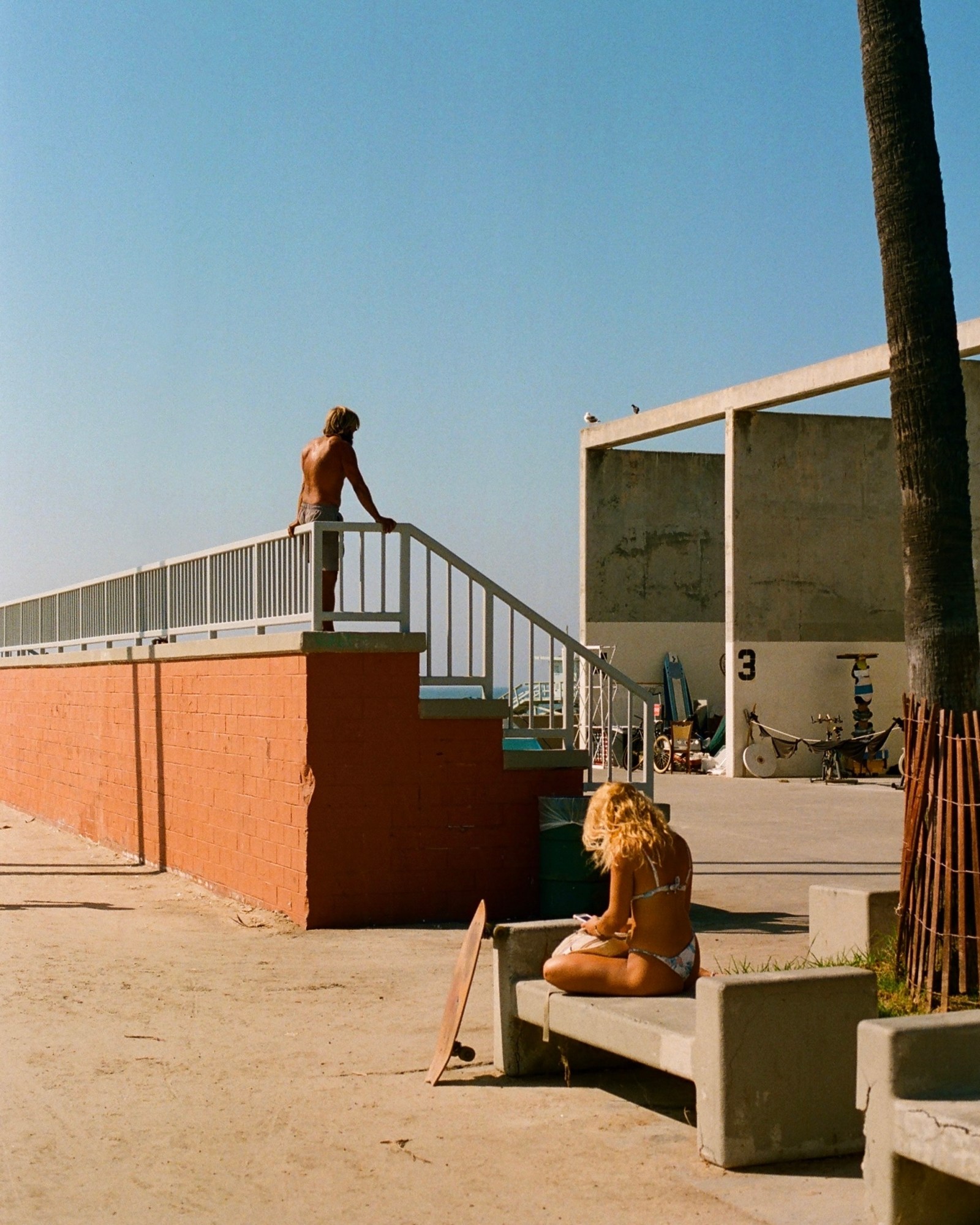 two people in bathing suits alongside venice beach