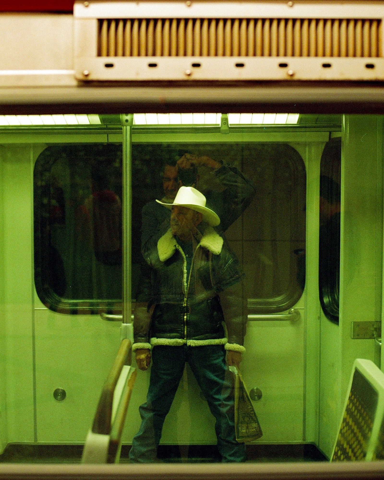 a man in a cowboy hat on the train