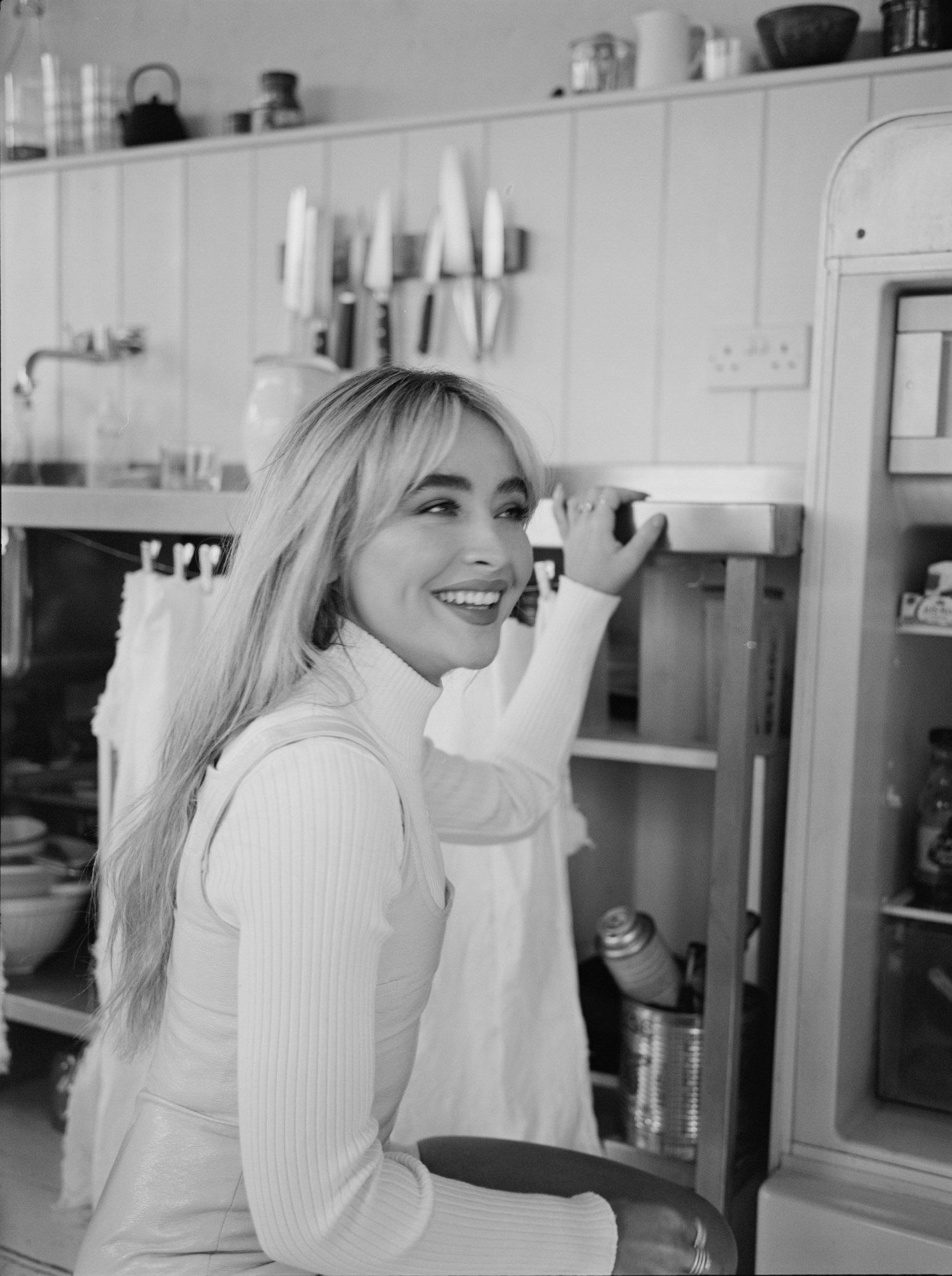 sabrina carpenter, wearing a mockneck sweater