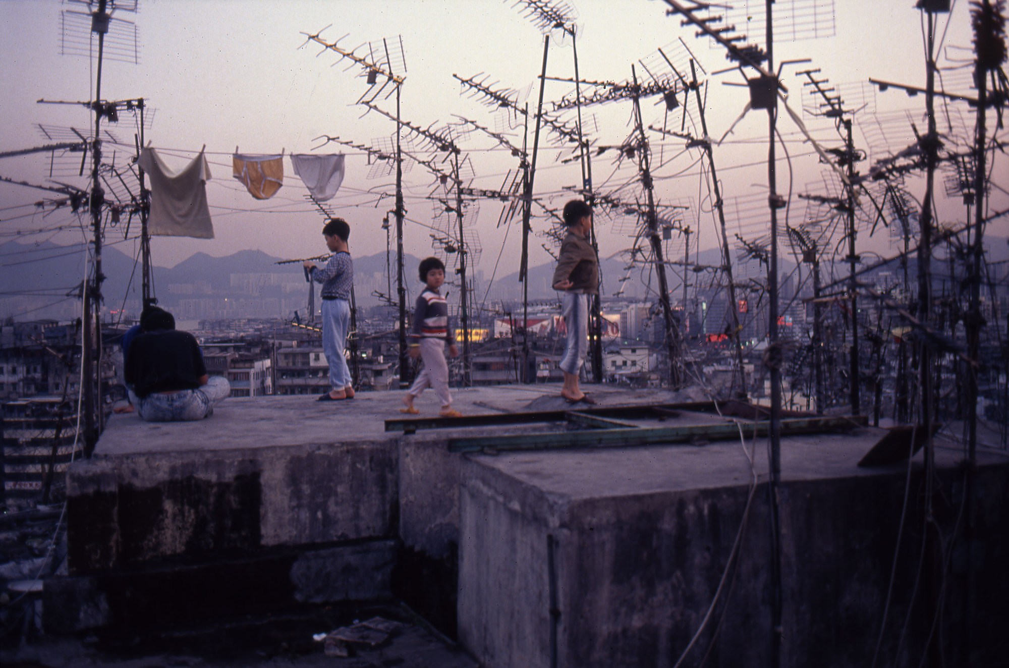 Three children play on the roof of Kowloon Walled City