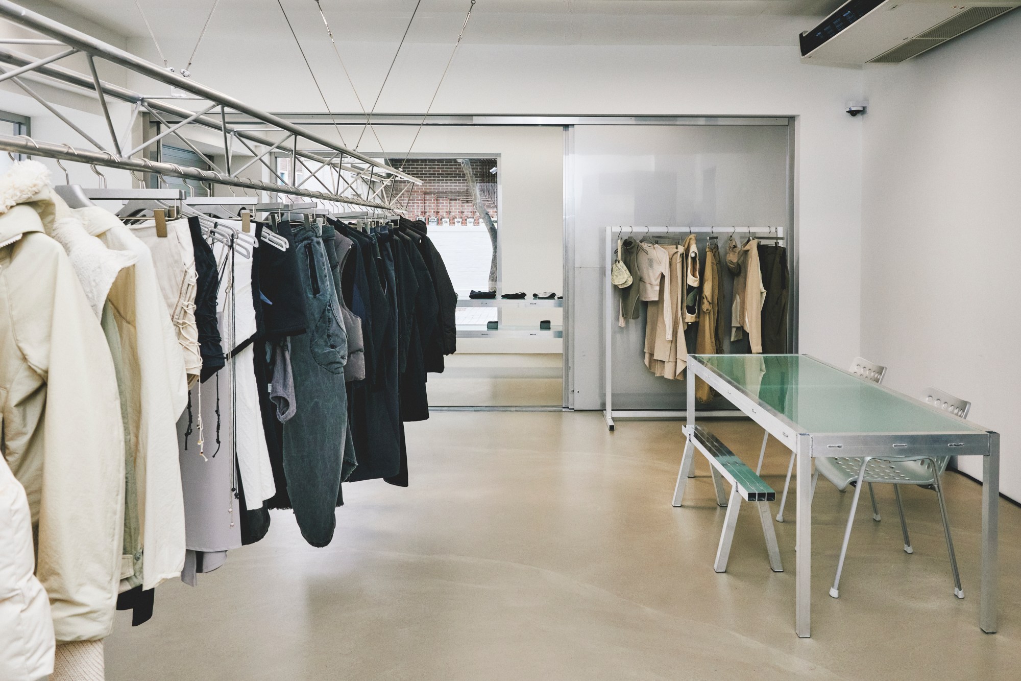 an interesting clothes rail displays monochrome items in a stripped back fashion store in seoul