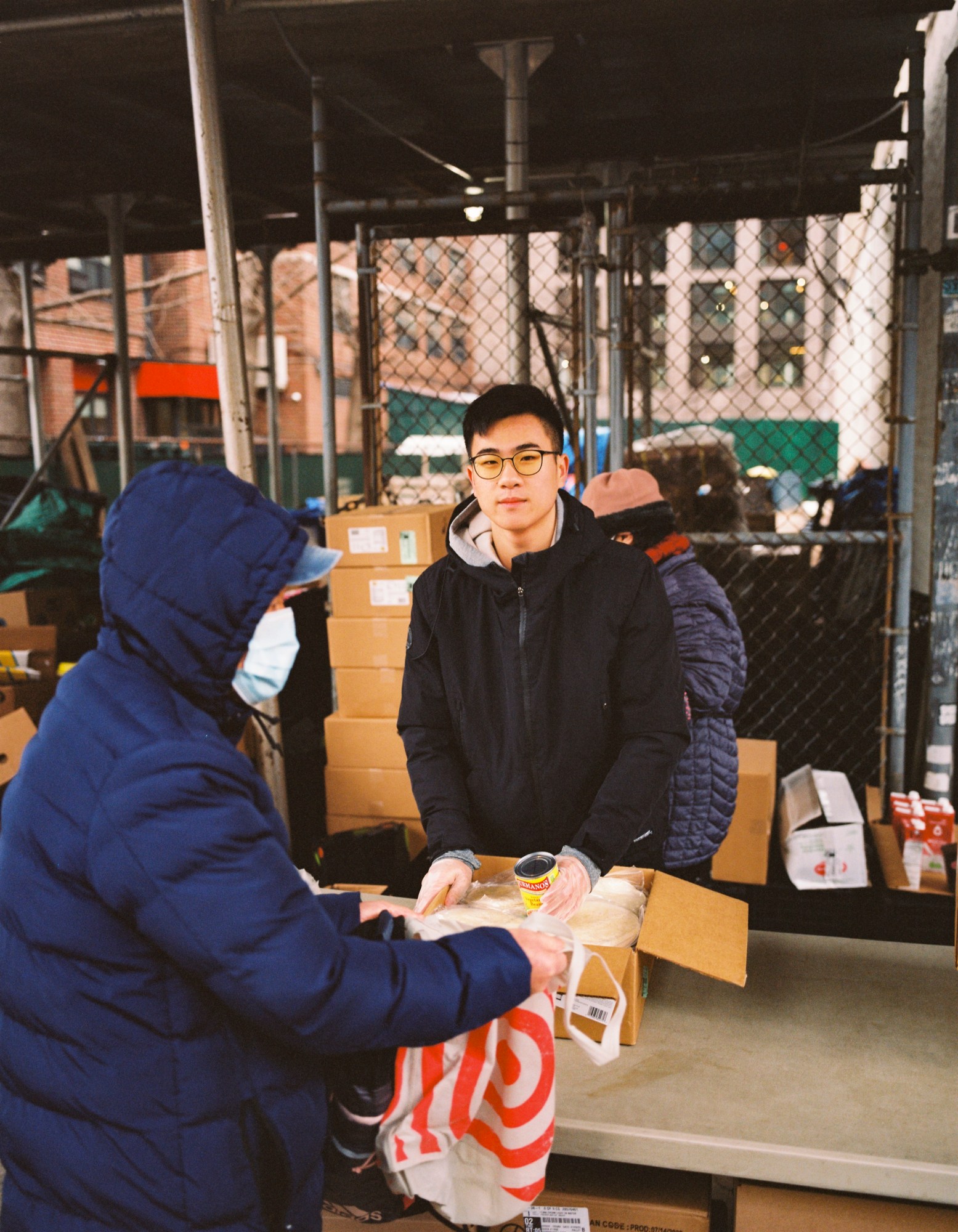 jacky lin handing out food at a makeshift table in chinatown