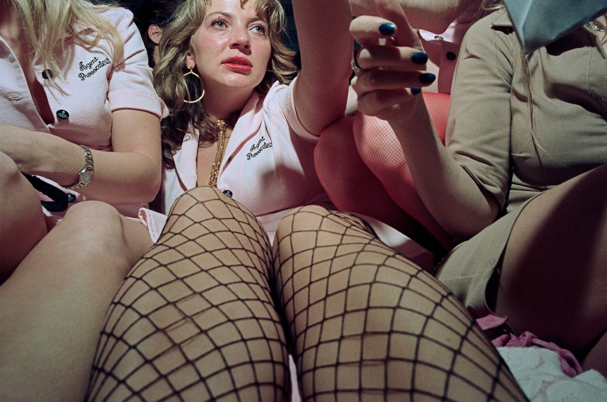 Close-up image of women in pink Agent Provocateur uniforms at a party