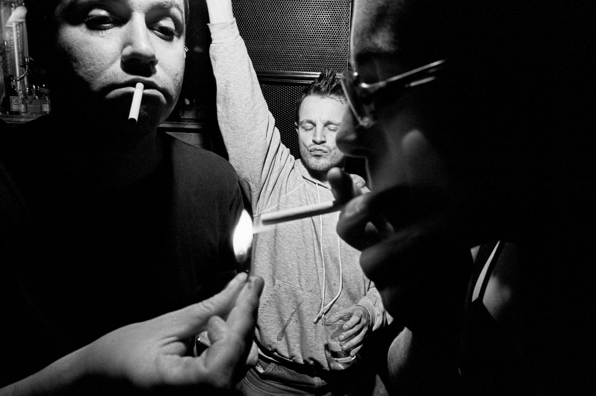 Black-and-qhite image of a man dancing with his eyes closed at a party