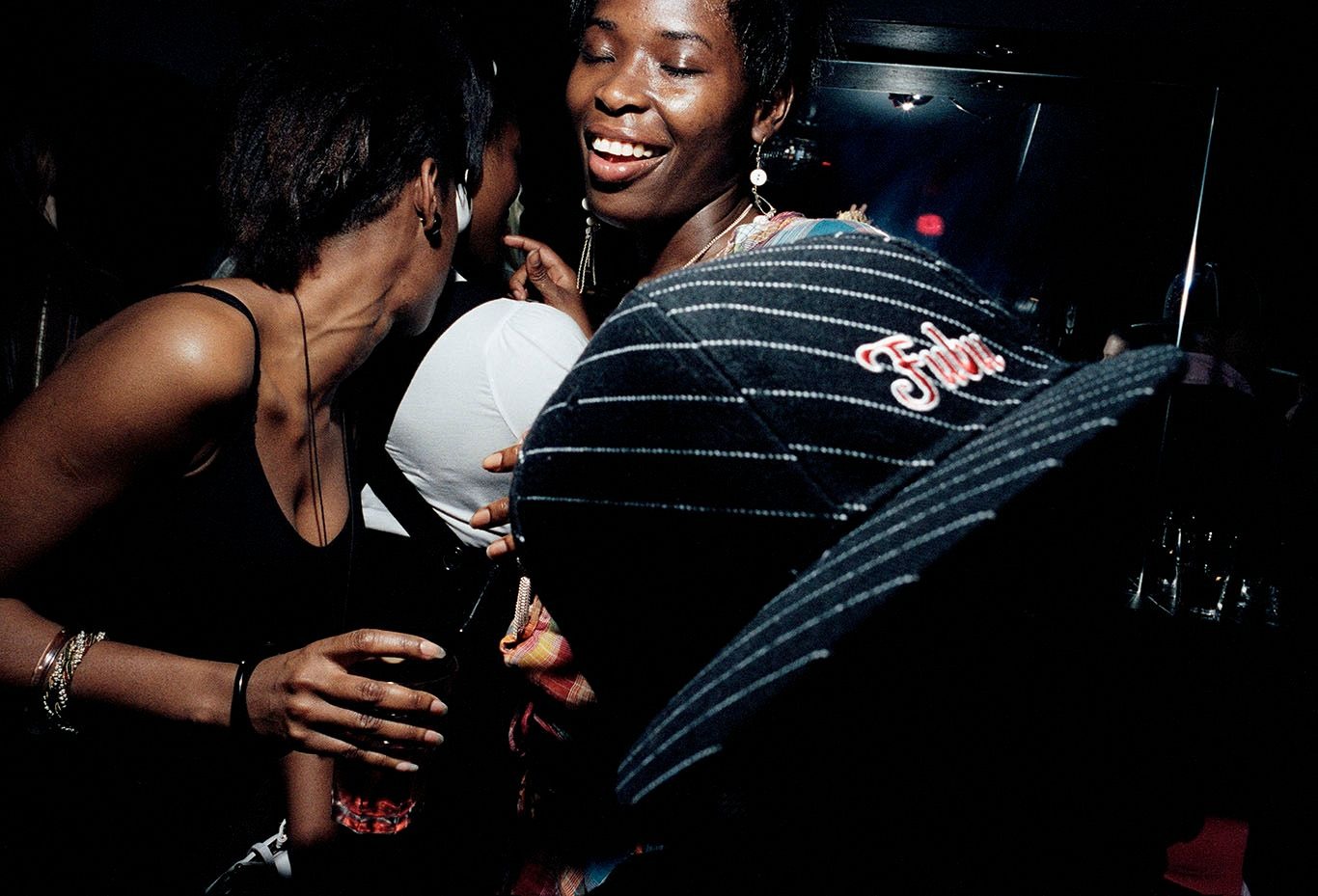 Smiling crowds dance at a party