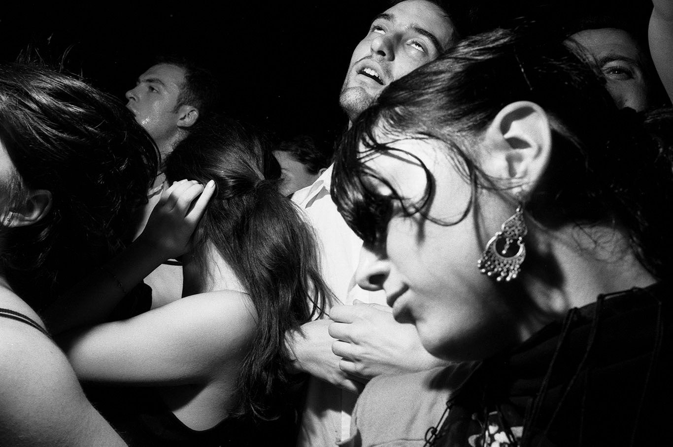 Black-and-white image of people dancing at a party