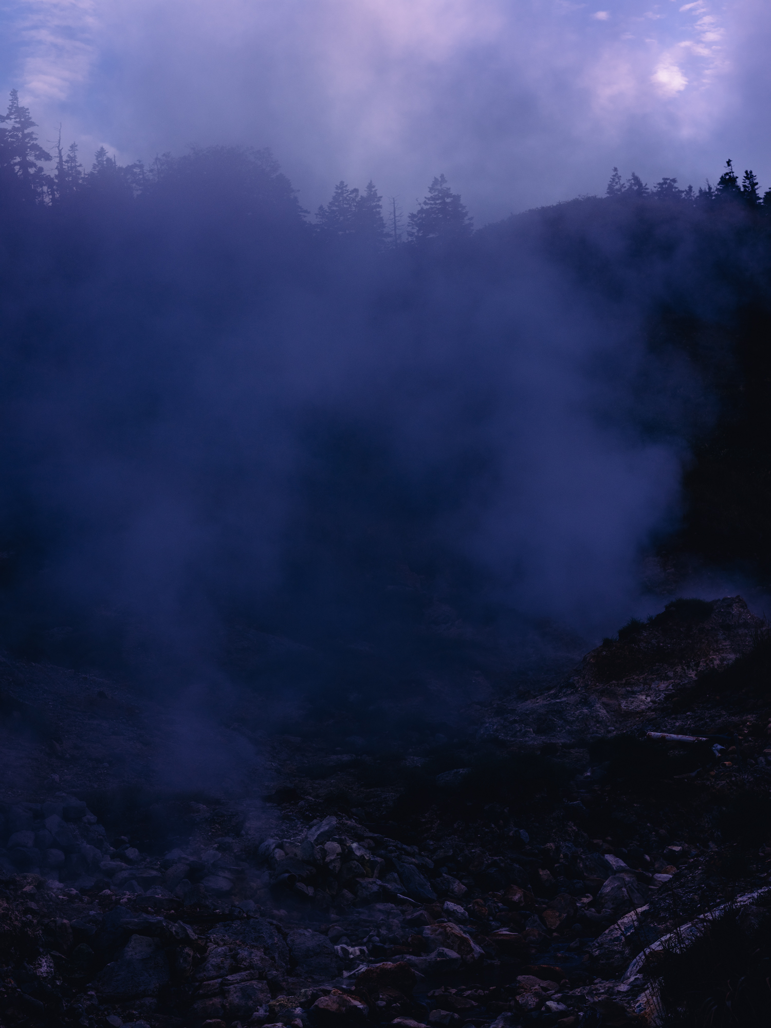 Purple smoke rising off a Japanese wild hot spring