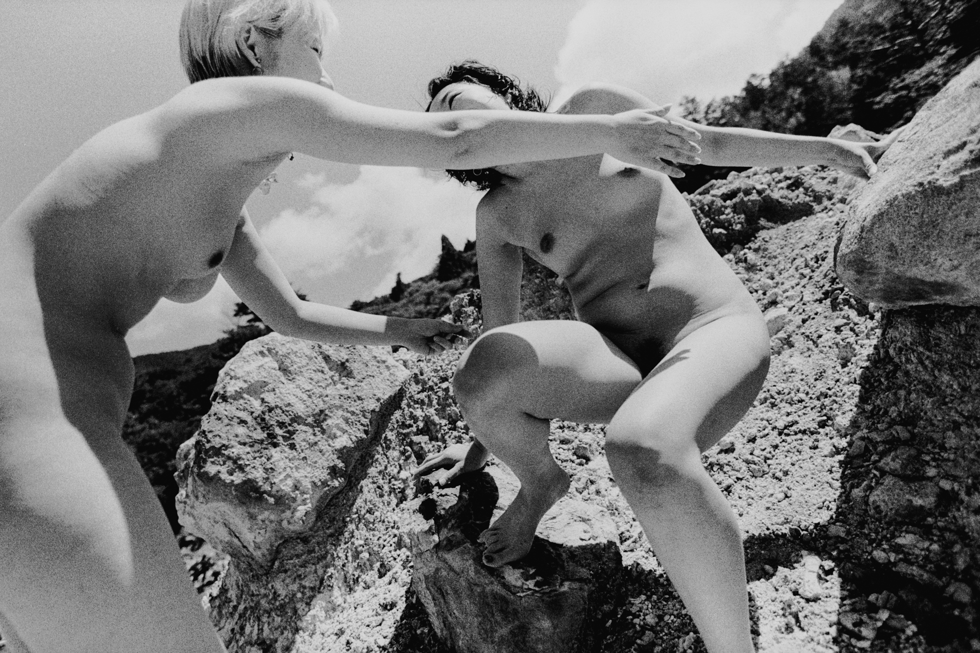 Black-and-white image of two naked women embracing at a Japanese hot spring