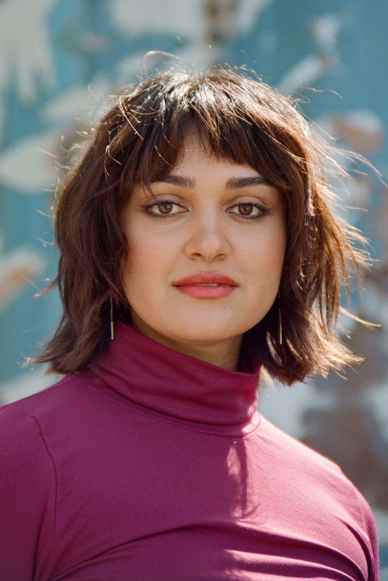 close up shot of ariela wearing a magenta top