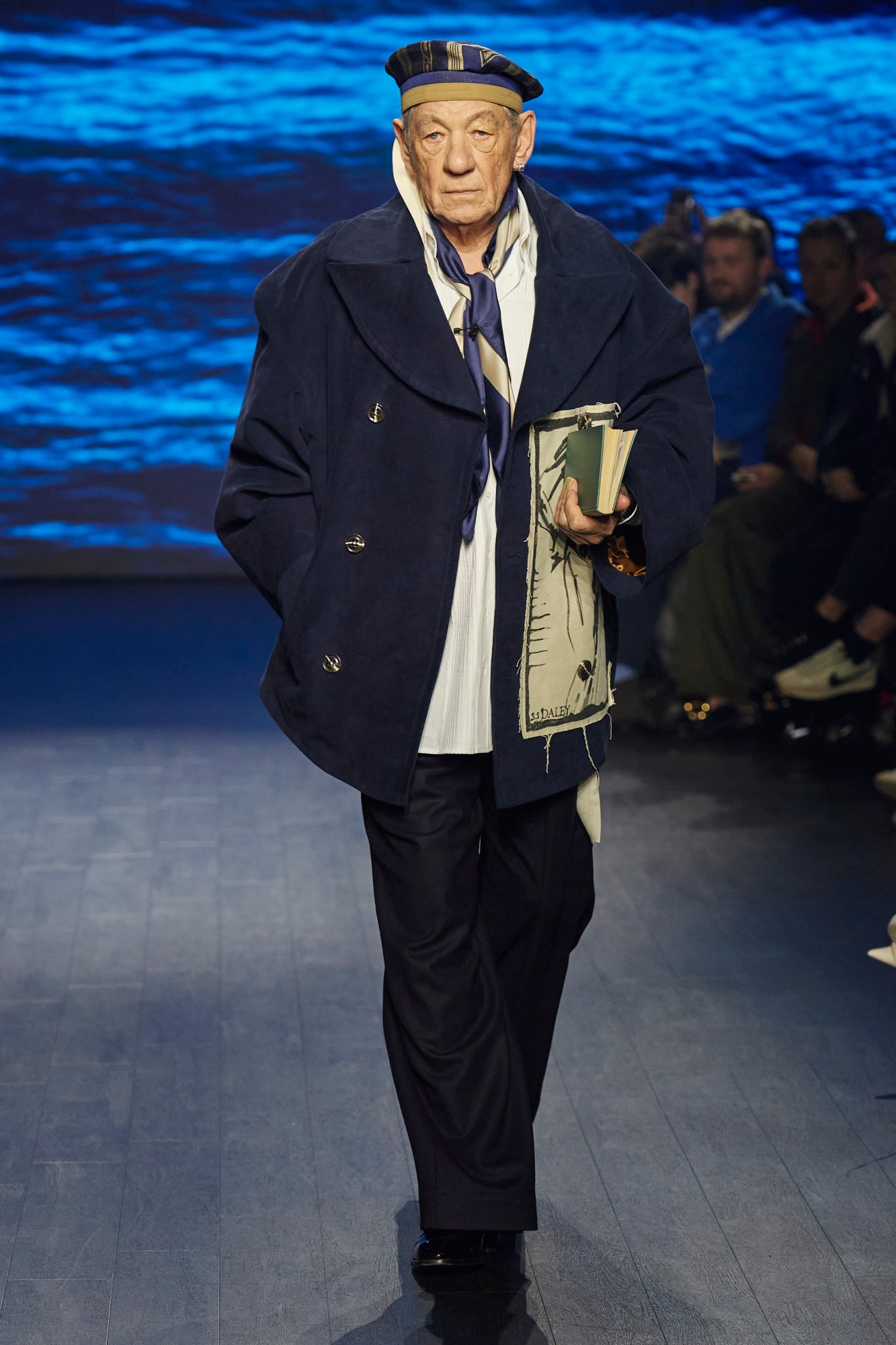 Ian McKellen walking for S.S. Daley AW23 with a male nude sewn to his coat