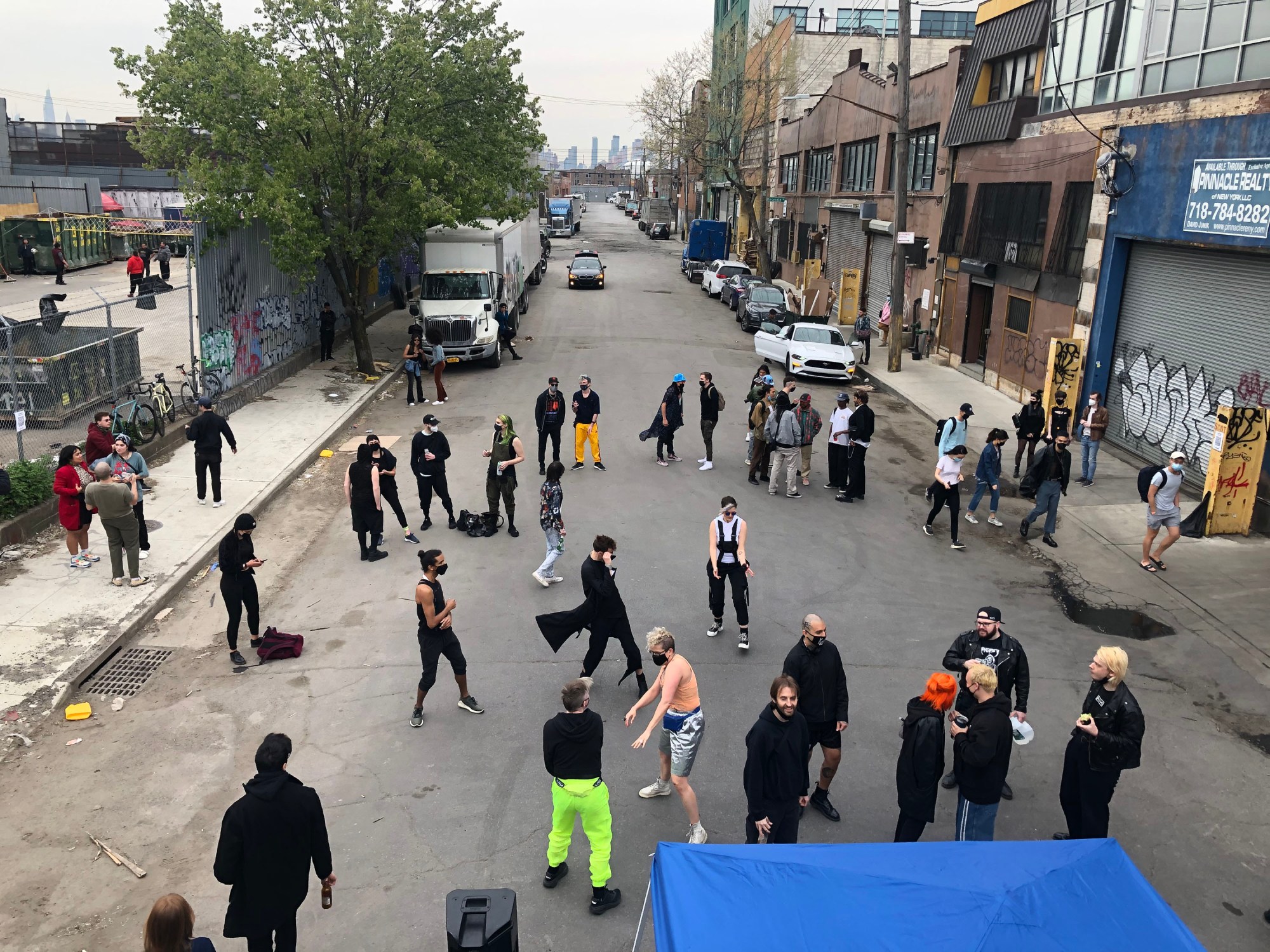 dancers gathering in the street at a rave in the early hours of the morning