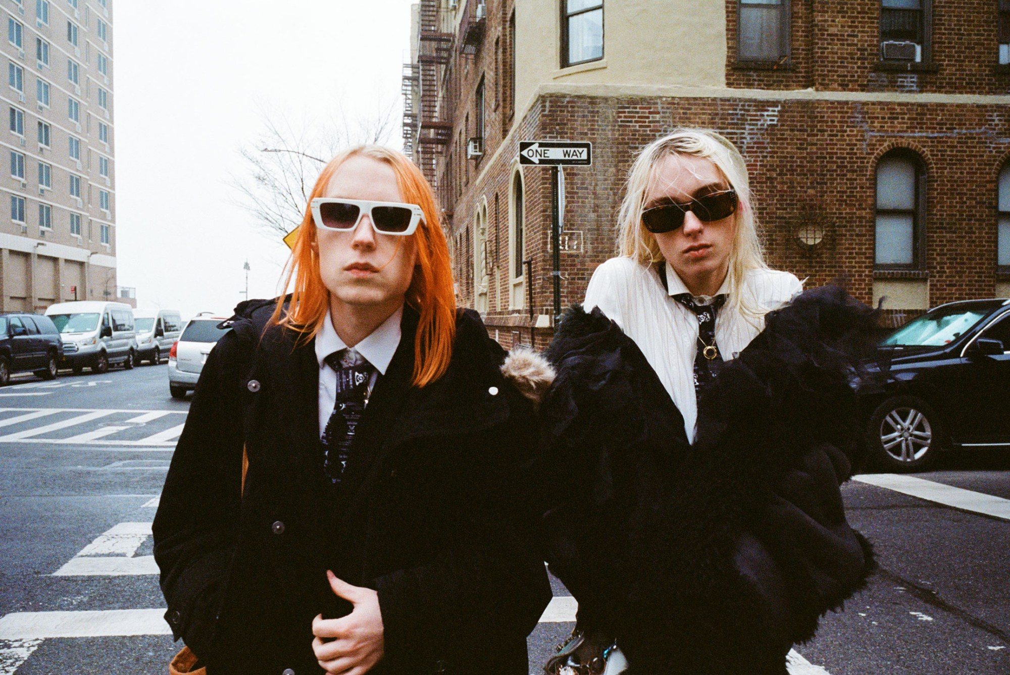 frost children stand on in the street by coney island boardwalk wearing sunglasses