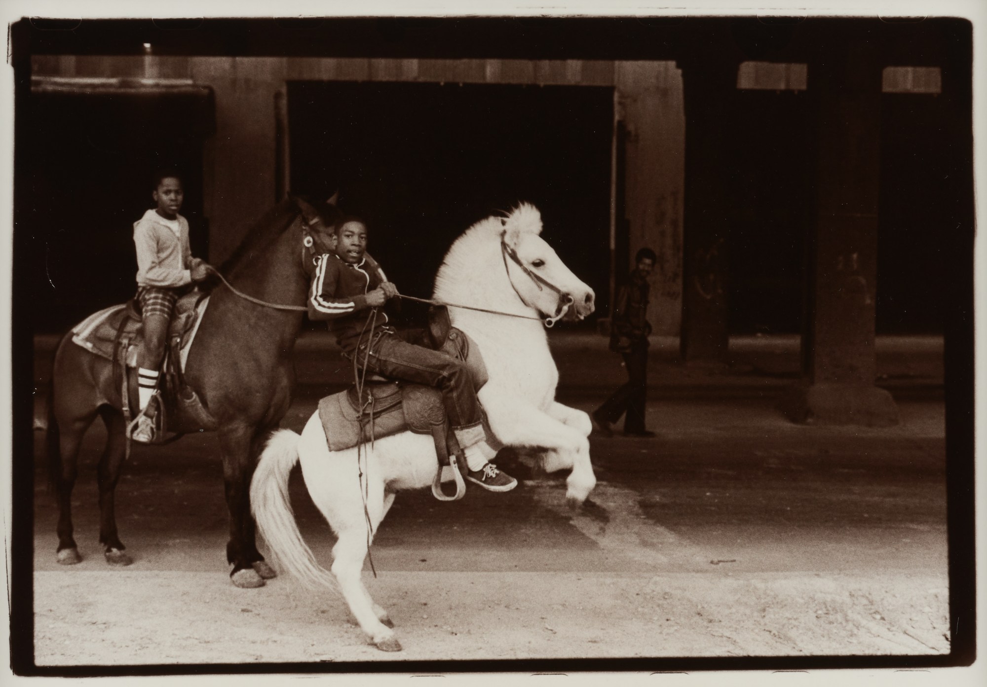 two young boys on horses