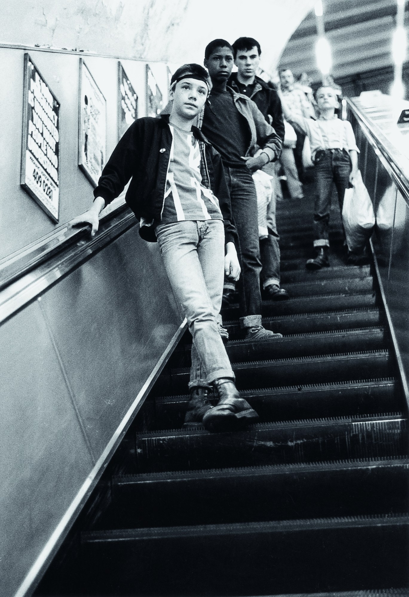 three skinheads standing on a london tube escalator