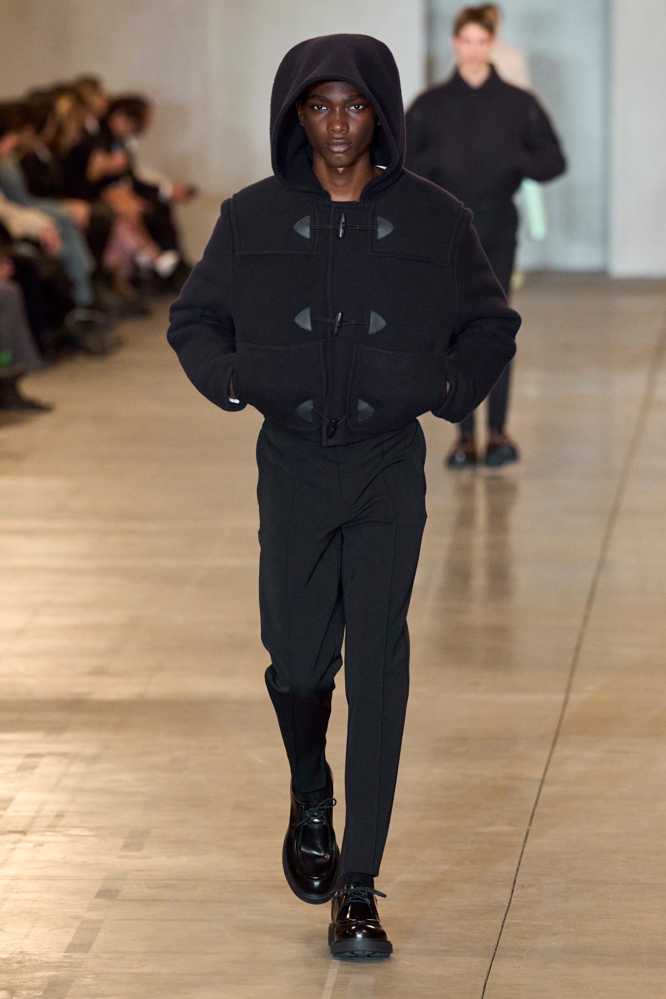 A model walking the Prada Men's AW23 runway