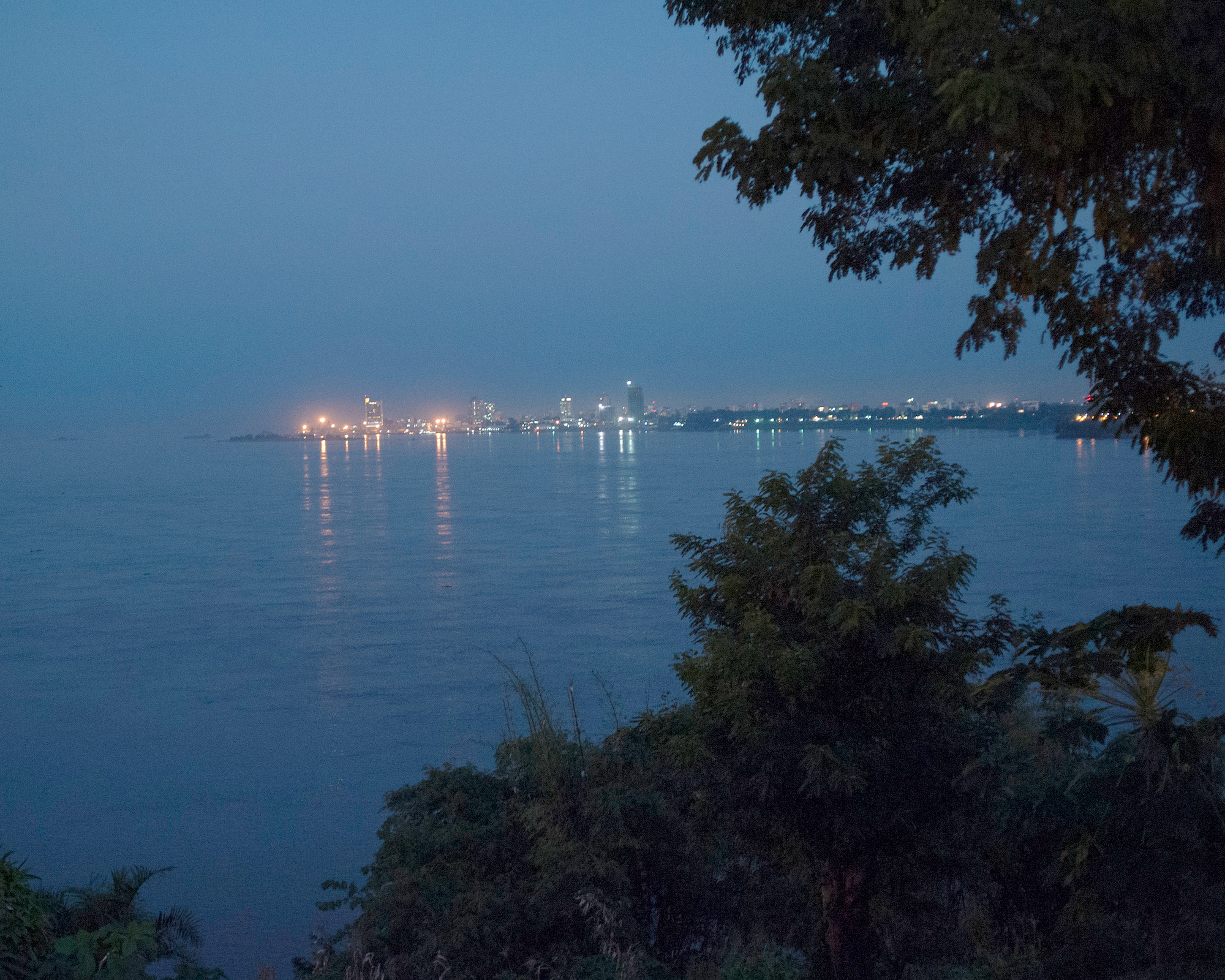 a city on the shore lit up at night