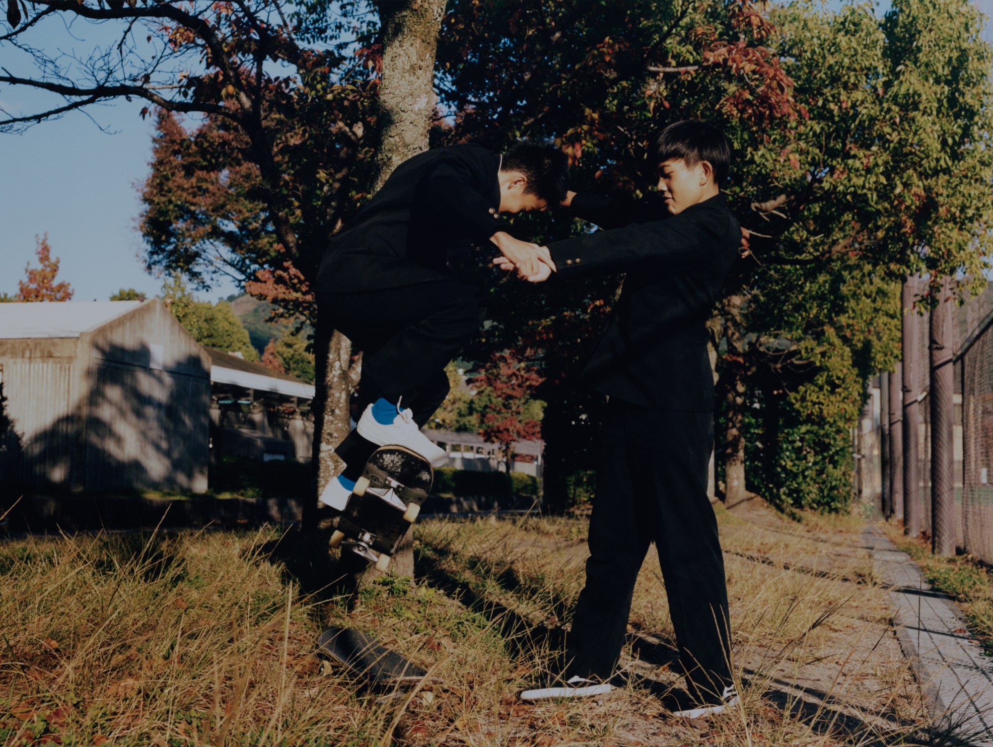 skateboarders on a sidewalk in japan