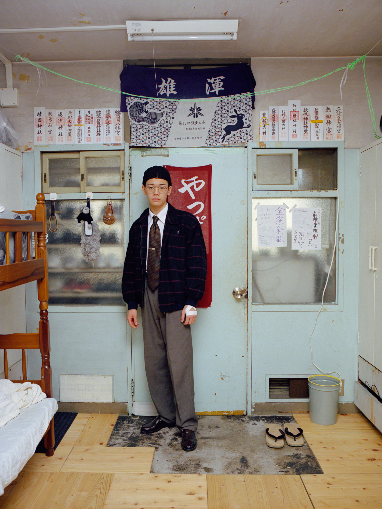 A Japanese teenager poses in his bedroom